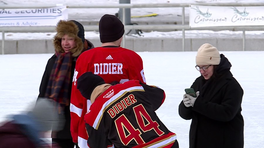 A Griffins player signs an ice skater's jersey at Great Skate Winterfest in Rosa Parks Circle. (Jan. 19, 2025)